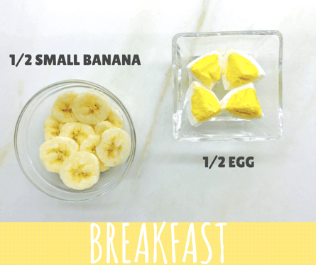 Top down photo showing 1/2 small banana cut into rounds. 1/2 egg cut into quarters
