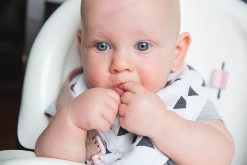 baby with finger in mouth