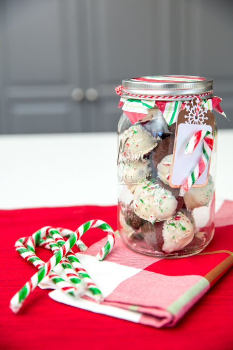 cookies in a jar with candy canes on a table
