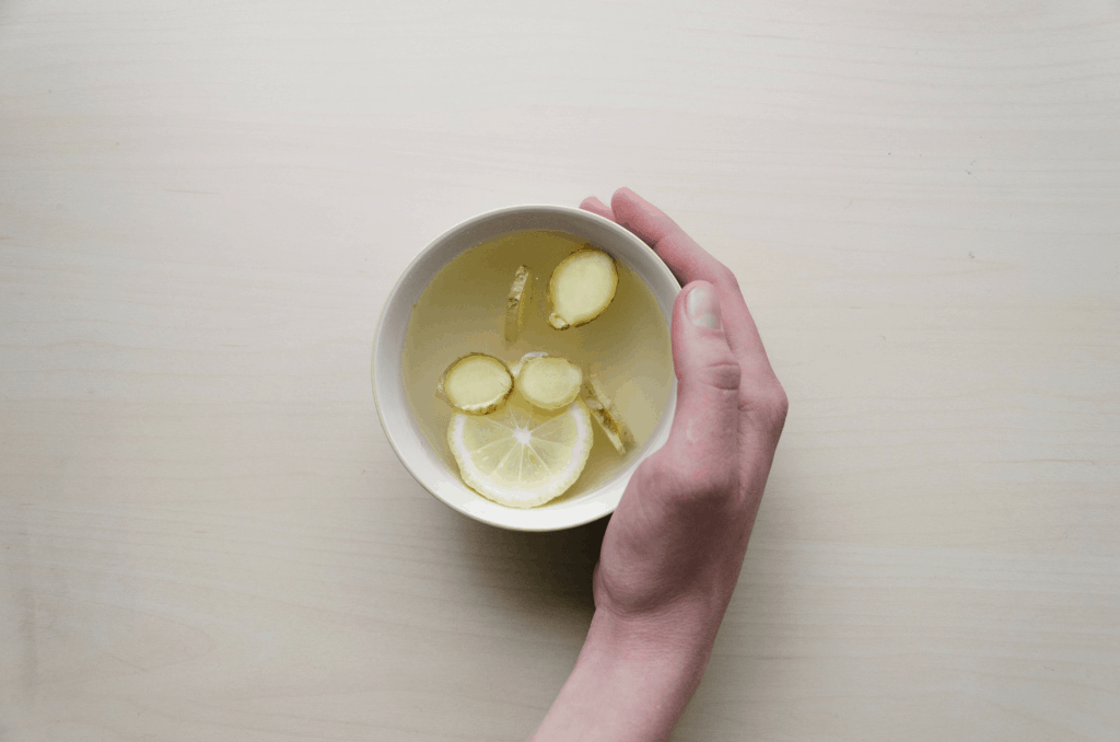 ginger tea in a mug with hot water and lemon to reduce nausea in pregnancy