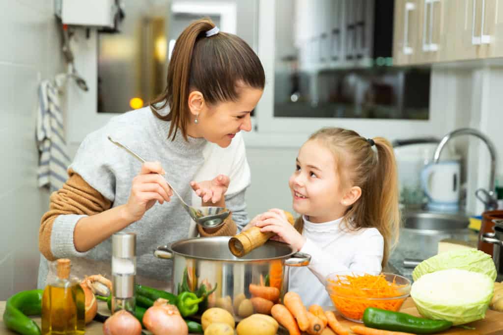 Child cooking with mother