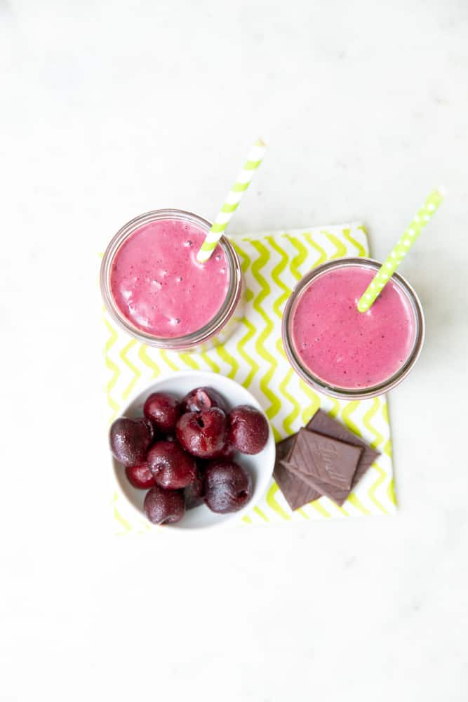 top down view of chocolate cherry smoothies with cherries and chocolate