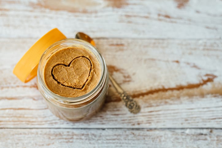 jar of peanut butter with a heart shape carved into it