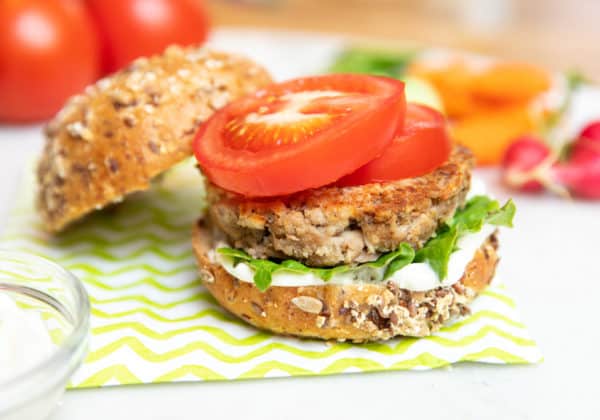 tuna burgers on seedy buns with tomatoes lettuce and sauce
