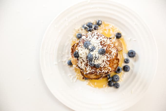 flourless banana pancakes with maple syrup and blueberries