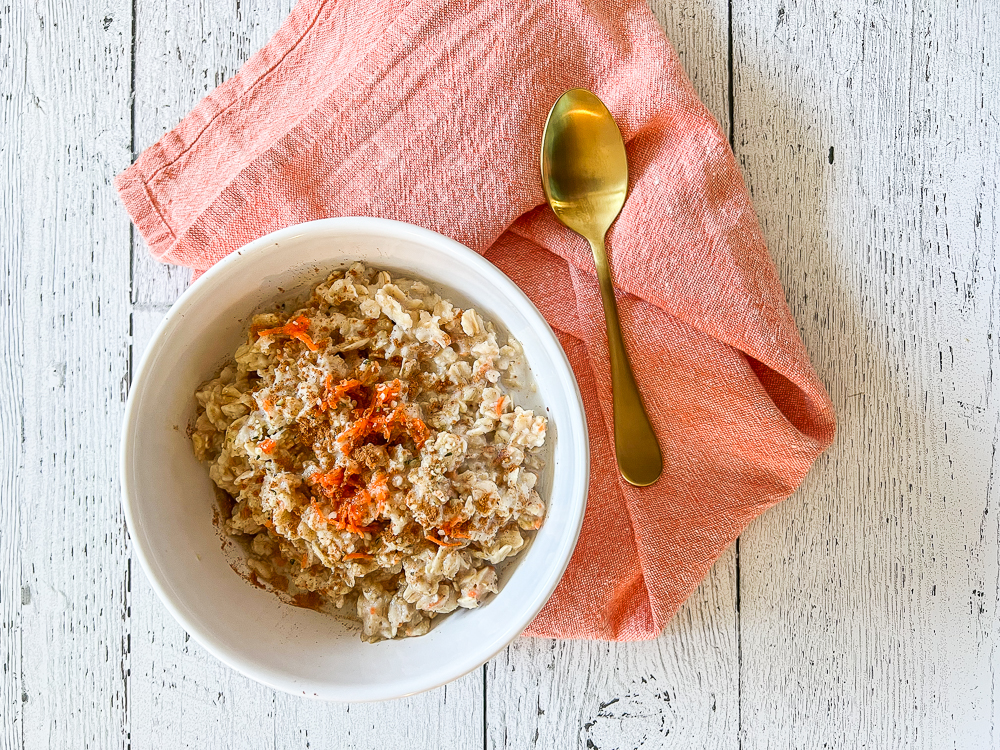 carrot cake oatmeal in a bowl with napkin and spoon