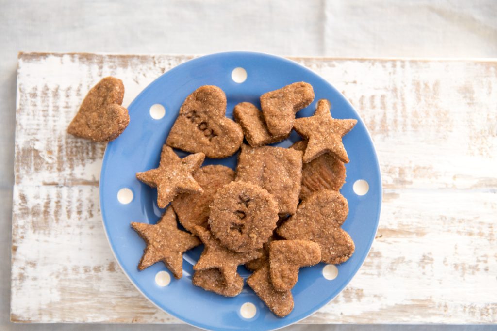 iron rich teething biscuits for babies cut into shapes on a blue plate