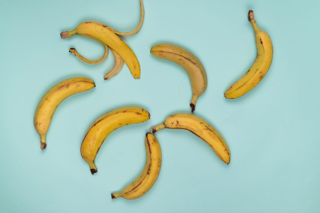 ripe bananas scattered on a blue surface