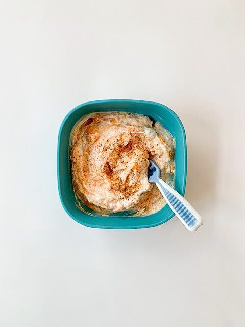 sweet potato mixed with yogurt and sprinkled with cinnamon in a bowl