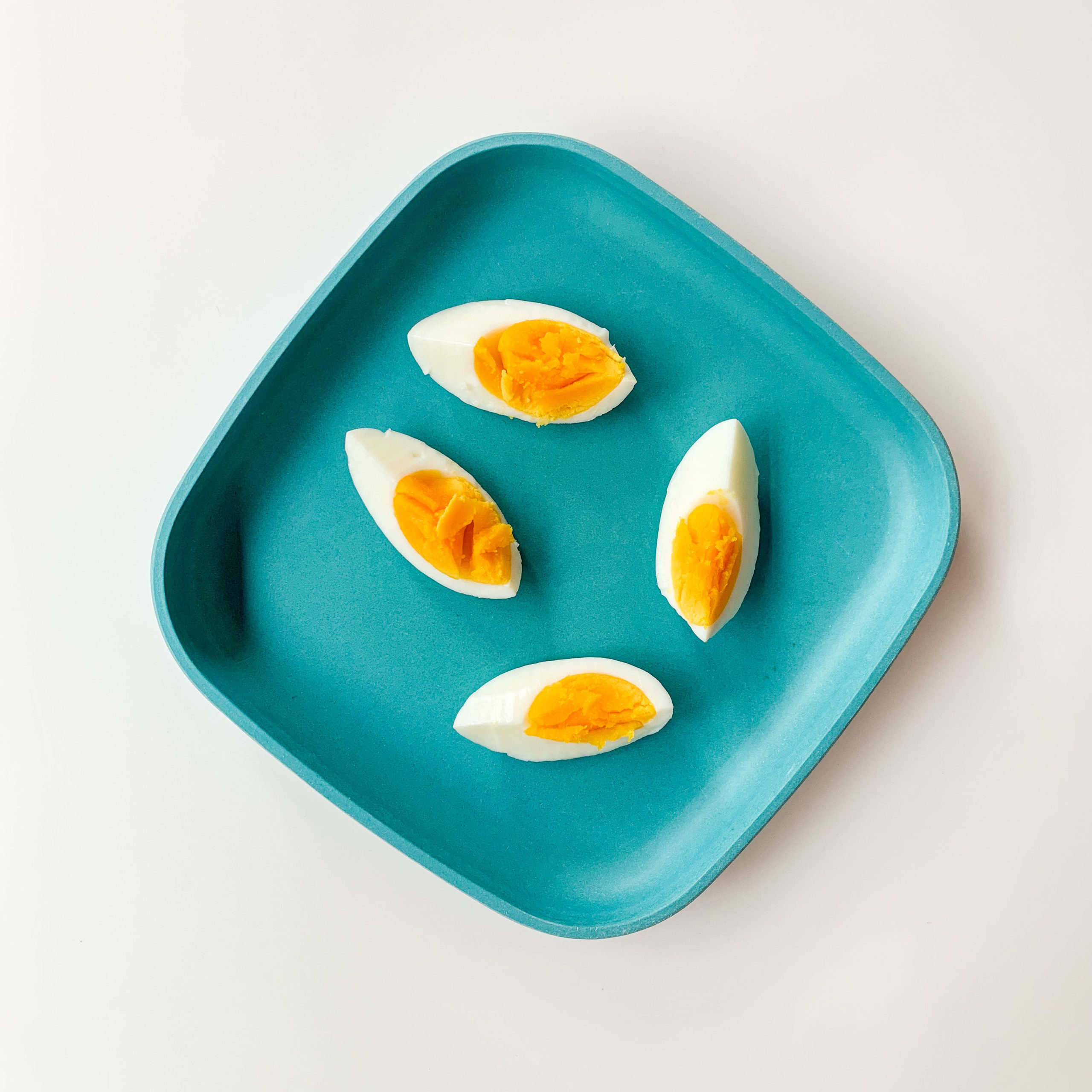 hard boiled egg wedges on a blue plate