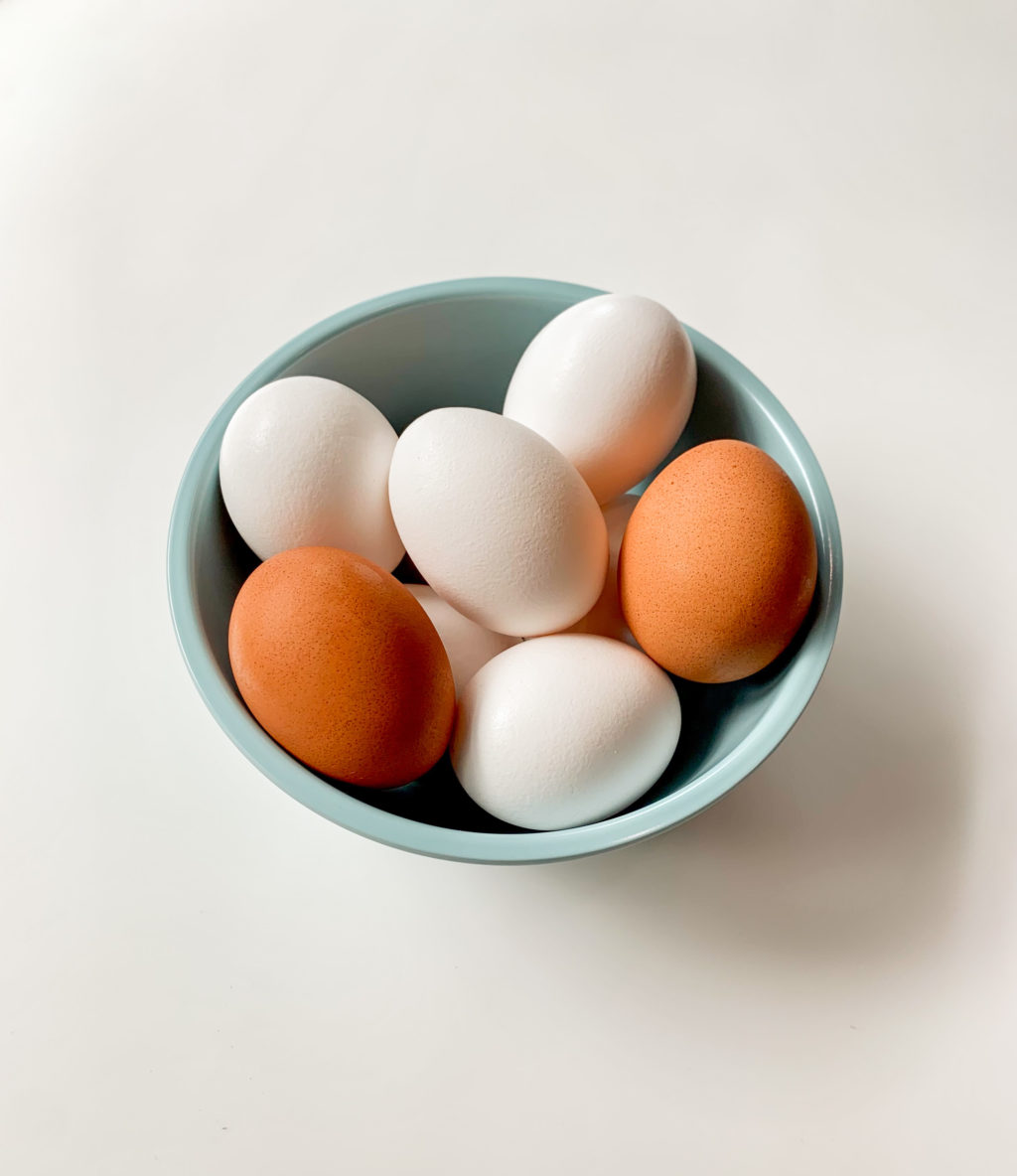 Brown and white eggs in a bowl
