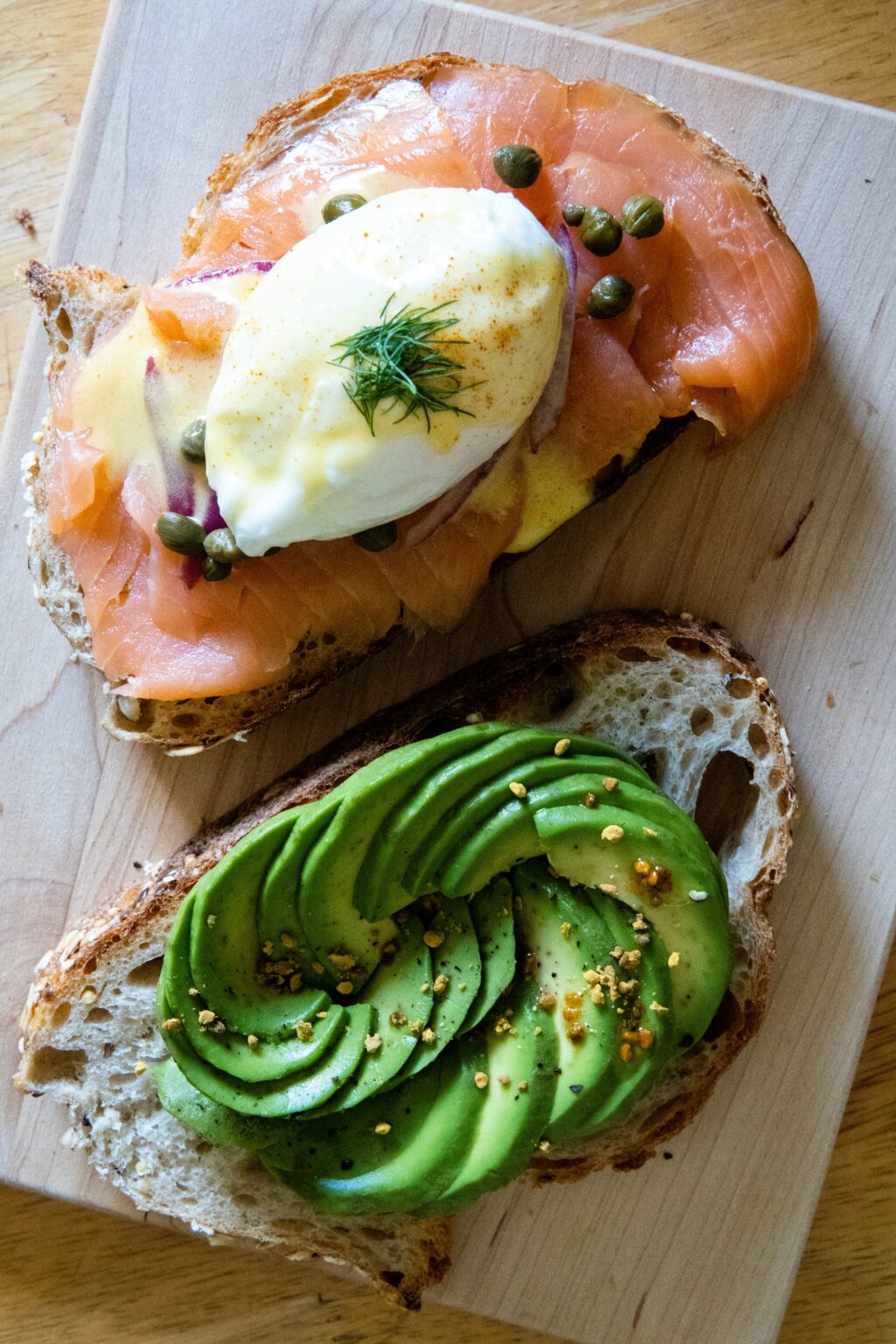 top down view of sourdough bread topped with foods to avoid when pregnant such as smoked salmon and runny eggs