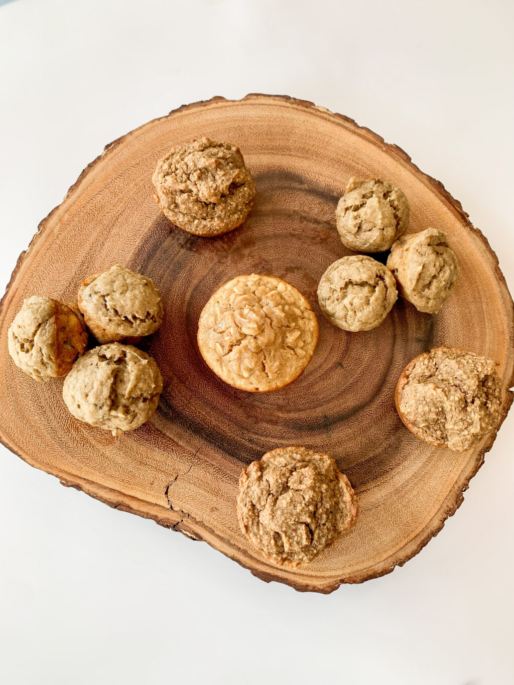 top down view of various muffins on a wooden board