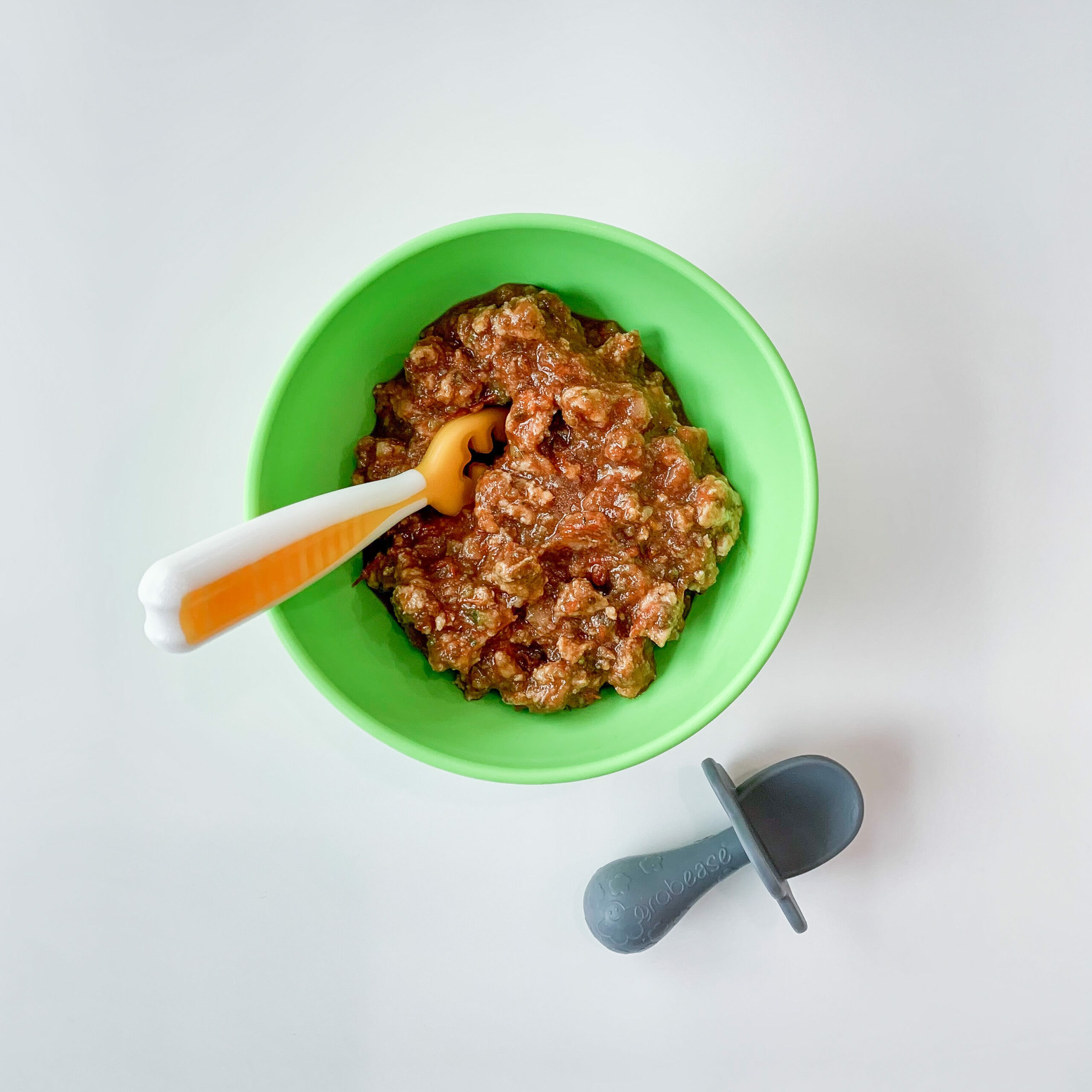 ground chicken with meat sauce in a small bowl, top down