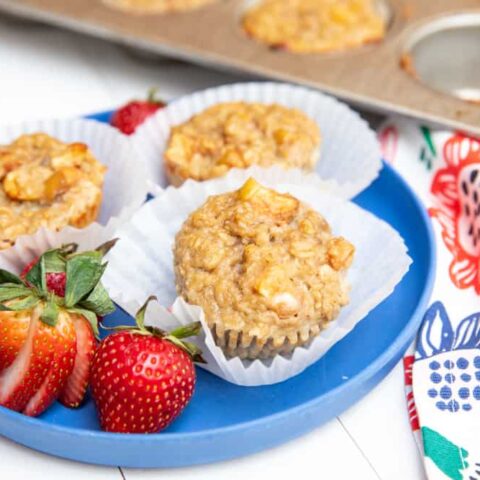close up of oatmeal apple muffins on a blue plate