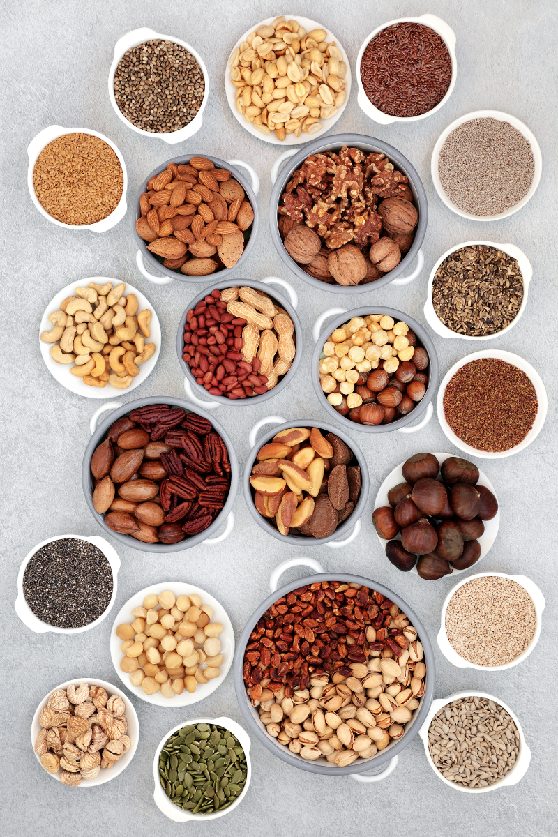 top down view of a bunch of seeds and nuts in small bowls