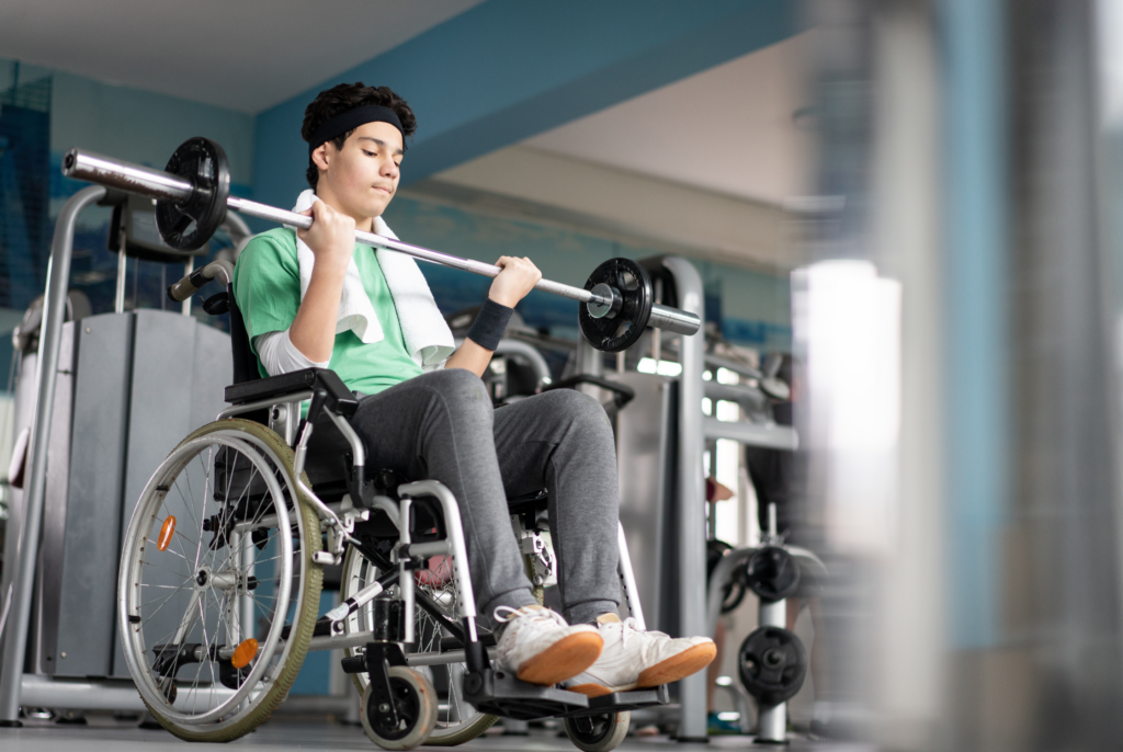 side view of a teenager in a wheelchair working out with a barbell