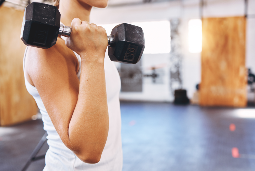close up of a teenager holding a dumbbell