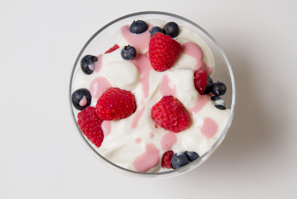 top down view of yogurt topped with berries