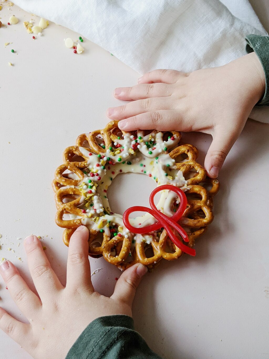 top down view of child's hands holding chocolate wreath