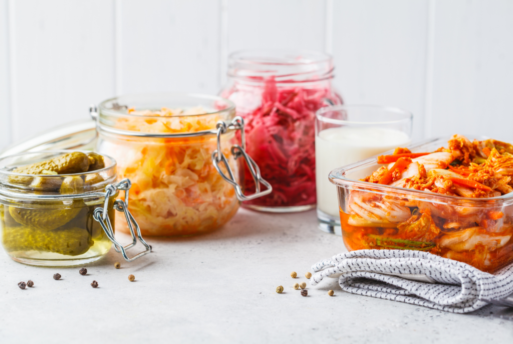 close up of a bunch of fermented foods such as yogurt, sauerkraut and kimchi